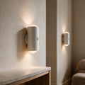 White Ambient Motion Wall Lights casting warm light in a calm beige hallway with an oak console and limestone top.