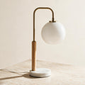 Auris Globe Table Lamp — full product in a warm ivory setting