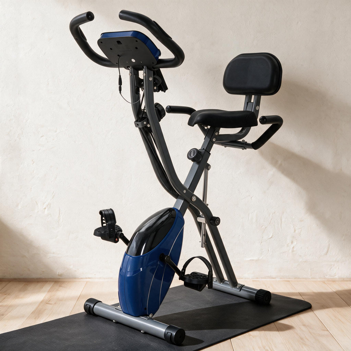Folding Exercise Bike - Blue — styled in a warm neutral indoor setting.