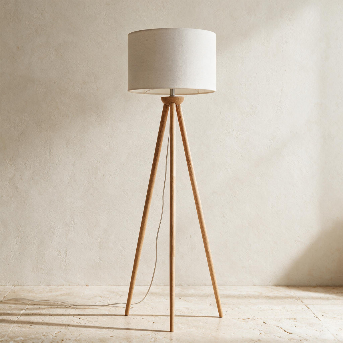 Lirios Tripod Floor Lamp — full product in a warm ivory setting