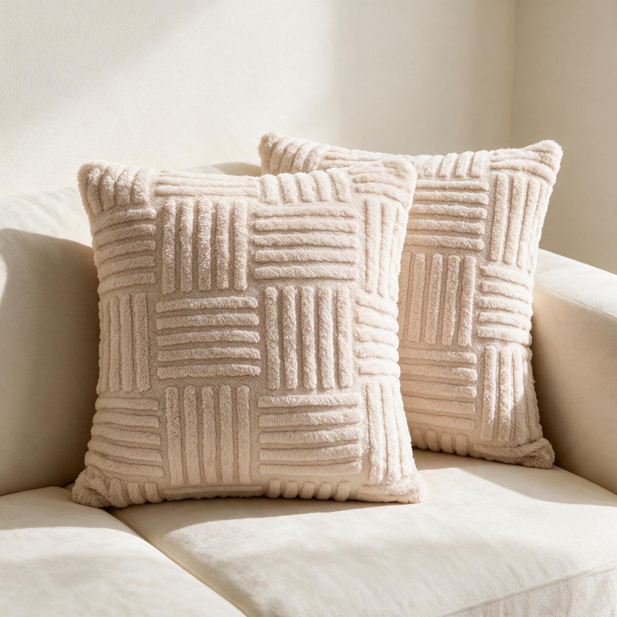 Two warm beige Textured Plush Pillow Covers styled on a cream sofa.