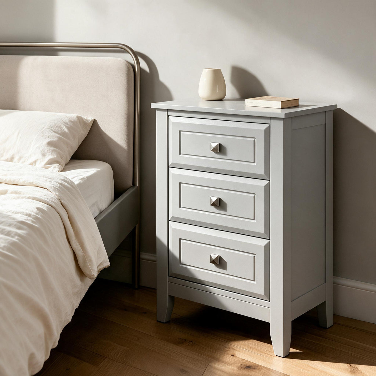 Three-Drawer Nightstand — Gray — in a warm neutral home setting; styling accessories not included
