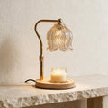 Gold Tulip Candle Warmer Lamp with a fluted glass shade and wooden base, warming an unlit jar candle.